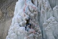 Ice climbing competition. Climbers climb an ice cliff Royalty Free Stock Photo