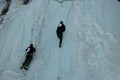 Ice climbing competition. Climbers climb an ice cliff Royalty Free Stock Photo