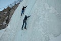 Ice climbing competition. Climbers climb an ice cliff Royalty Free Stock Photo
