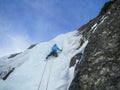 Ice climbing on a frozen icefall