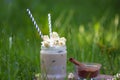 Ice cocoa with cinnamon and whipped cream adorned with caramel popcorn