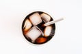 Ice coffee in glass glass cup a tube on white background, top view. Royalty Free Stock Photo