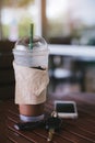 Ice coffee , Key and smartphone in cafe Royalty Free Stock Photo