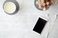 Ice coffee, phone and headphones on white wooden table Royalty Free Stock Photo