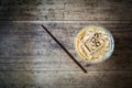 Ice coffee in plastice glass. Top view on wooden background.