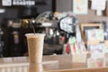 Ice coffee in take away cup.Indoor Cafe. Royalty Free Stock Photo