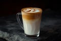 Ice coffee in a tall glass with cream poured over black table. Cold summer drink on a dark background Royalty Free Stock Photo