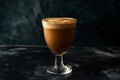 Ice coffee in a tall glass with cream poured over black table. Cold summer drink on a dark background Royalty Free Stock Photo