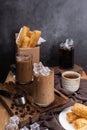 Ice coffee in transparent glass and roasted coffee beans and Crispy Pie dessert on wood. black background studio. vertical photo Royalty Free Stock Photo