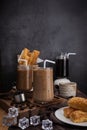Ice coffee in transparent glass and roasted coffee beans and Crispy Pie dessert on wood. black background studio. vertical photo Royalty Free Stock Photo