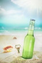 Ice cold bottle of lager or soda on a beach