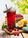 Ice cold drink jar glass with raspberry and lemon cocktail . Royalty Free Stock Photo