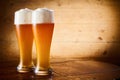 Ice cold glasses of frothy larger or wheat draft beer Royalty Free Stock Photo