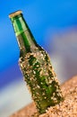 Ice cold green unlabelled bottle of beer in the