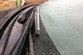 Ice covered car windshield with frozen wipers Royalty Free Stock Photo