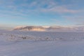 The ice covered fjord Tempelfjorden, with the mountain Templet in the background, and the snowmobile track in the