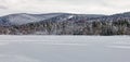 ice covered Richmond Pond and snow covered Berkshire mountains and evergreens Royalty Free Stock Photo