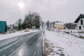 Ice-covered road in a village on the edge of a forest Royalty Free Stock Photo