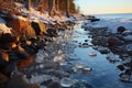 Ice-covered rocks along a shoreline photo - stock photography concepts