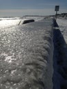 Ice covered sea wall at the ocean Royalty Free Stock Photo