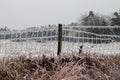 Ice covers wire fence with ice icicles Royalty Free Stock Photo