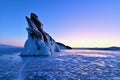 Ice Cracks Surface of Frozen Lake Baikal with Dragon Tail Rock on Ogoy Island at Lake Baikal Royalty Free Stock Photo