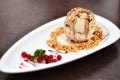 Ice cream almond in white dish on wooden table