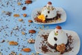 Ice cream background in the shape of two edible snowmen on white plates close up. Top view. Creative idea for Christmas. Royalty Free Stock Photo