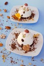 Ice cream background in the shape of two edible snowmen on white plates close up. Top view. Creative idea for Christmas. Royalty Free Stock Photo