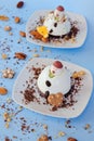 Ice cream background in the shape of two edible snowmen on white plates close up. Top view. Creative idea for Christmas. Royalty Free Stock Photo