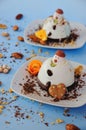 Ice cream background in the shape of two edible snowmen on white plates close up. Top view. Creative idea for Christmas. Royalty Free Stock Photo