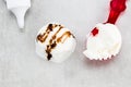 Ice cream balls with chocolate sauce on gray background, top vie