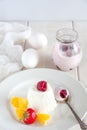 Ice cream with berries in white plate, yogurt and egg