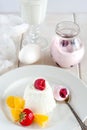 Ice cream with berries in white plate, yogurt and egg