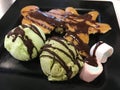 Ice-cream with berry; whip cream served with banana; waffle and chocolate