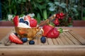 Ice cream with blueberries and strawberries in Golden Cup on table Royalty Free Stock Photo