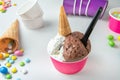 ice-cream with chocolate and stracciatella cream in tub with biscuits cones and sugared almonds Royalty Free Stock Photo