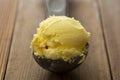 Ice cream closeup scoop, round icecream ball in scoop spoon on rustic wooden background