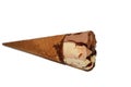 Ice cream of cocoa chocolate and vanilla cone with a chocolate bar piece in crispy wafer cones, selective focus of melting cold