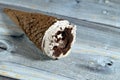 Ice cream of cocoa chocolate and vanilla cone with topping of chocolate chips cookies pieces in crispy wafer cones, melting cold