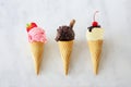 Ice cream cones, top view over white marble, strawberry, chocolate and vanilla Royalty Free Stock Photo