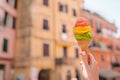 Tasty sweet ice-cream closeup in hands background old italian village Royalty Free Stock Photo