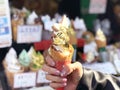 Ice cream cone covered with real gold leaf a famous street food in Japan Royalty Free Stock Photo