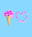 Ice cream cone with flowers and heart shape of petals over blue background