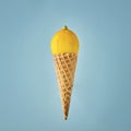 Ice cream cone with fresh lemon on blue background Royalty Free Stock Photo