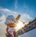 Ice cream cone held up to the hot summer sky Royalty Free Stock Photo