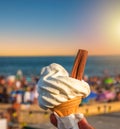 Ice cream cone held up to the hot summer sky Royalty Free Stock Photo