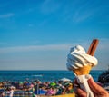 Ice cream cone held up to the hot summer sky Royalty Free Stock Photo