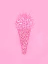 Ice cream cone made from confetti with tropical fashion pink cactus on paper background. Minimal pop art style and summer food con