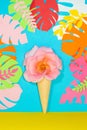 ice cream cone with pink rose flower head on blue jungle leaves tropical background, creative summer design Royalty Free Stock Photo